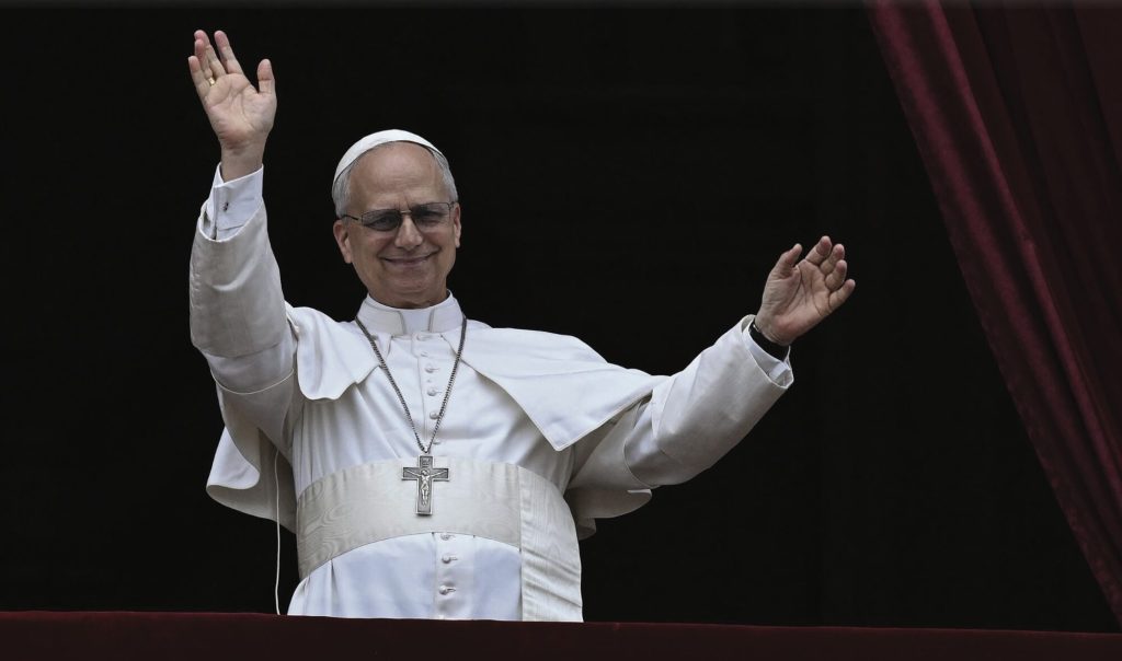 Pope Francis waving from the balcony at the Vatican